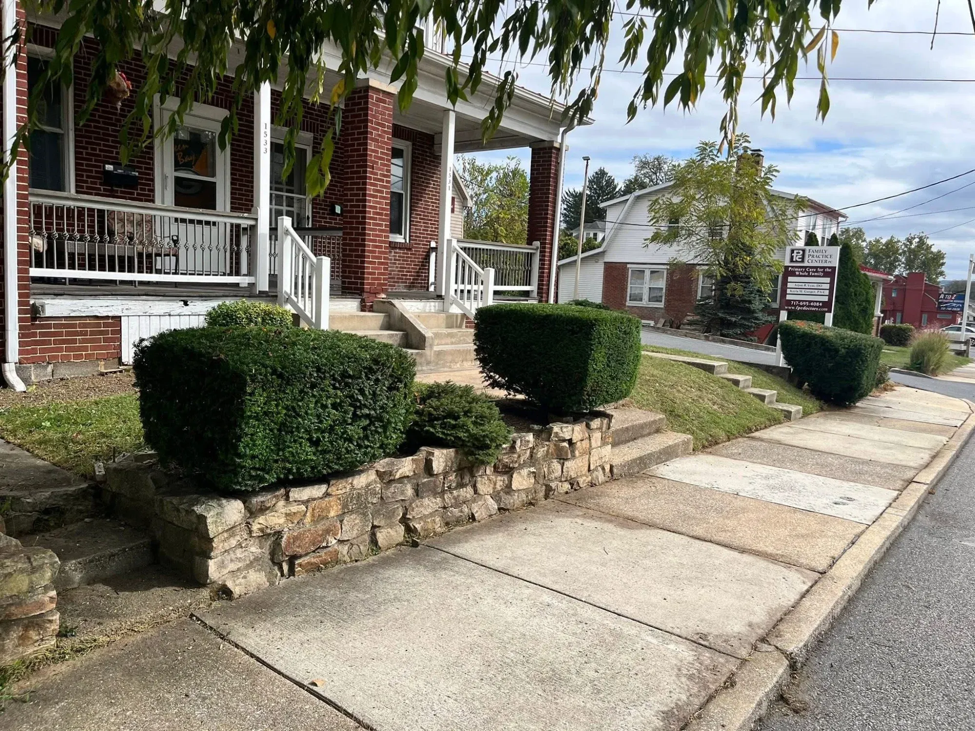 Front yard mulch bed with trimmed shrubs and annual flowers