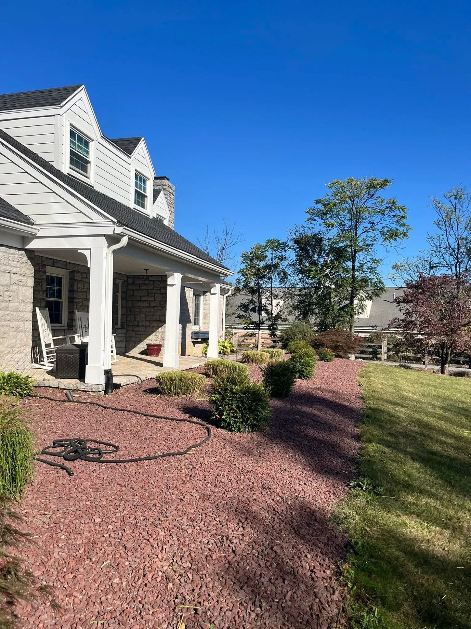 Decorative tree ring with river stone mulch installation