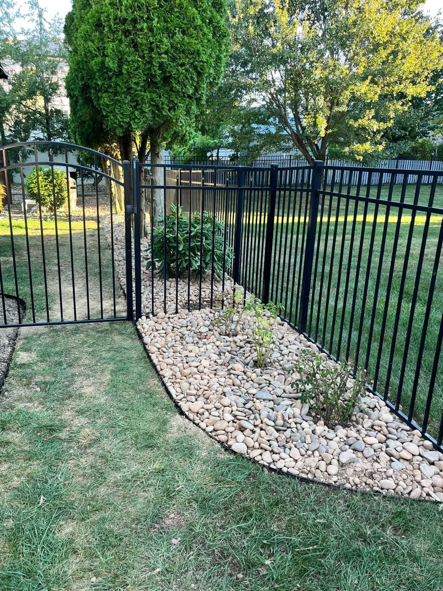 Commercial property shrub trimming and stone wall maintenance