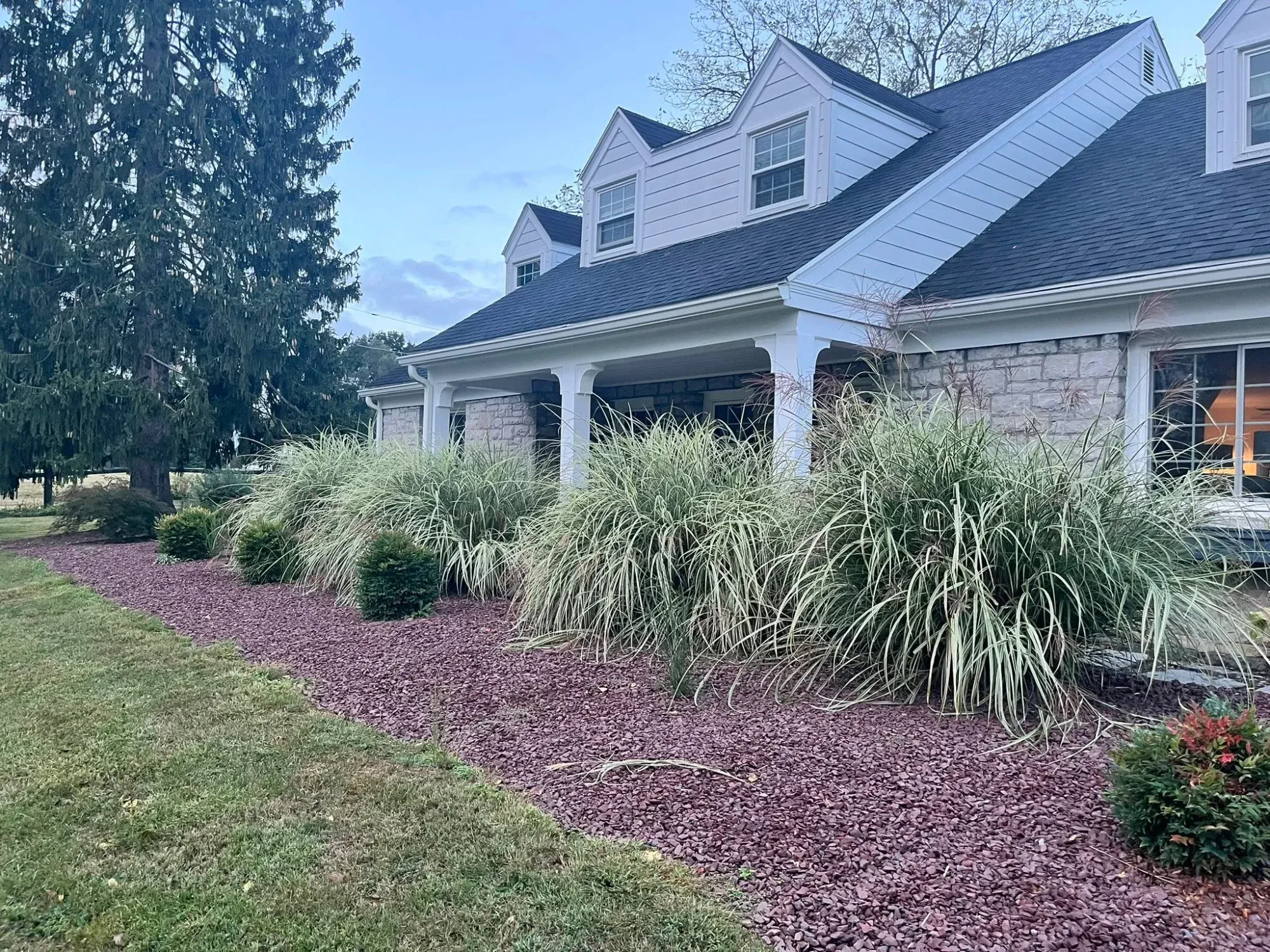 Front yard landscaping with shaped hedges and fresh mulch Harrisburg